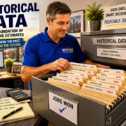 Professional evaluating historical data for electrical estimating with a file cabinet showing jobs won.